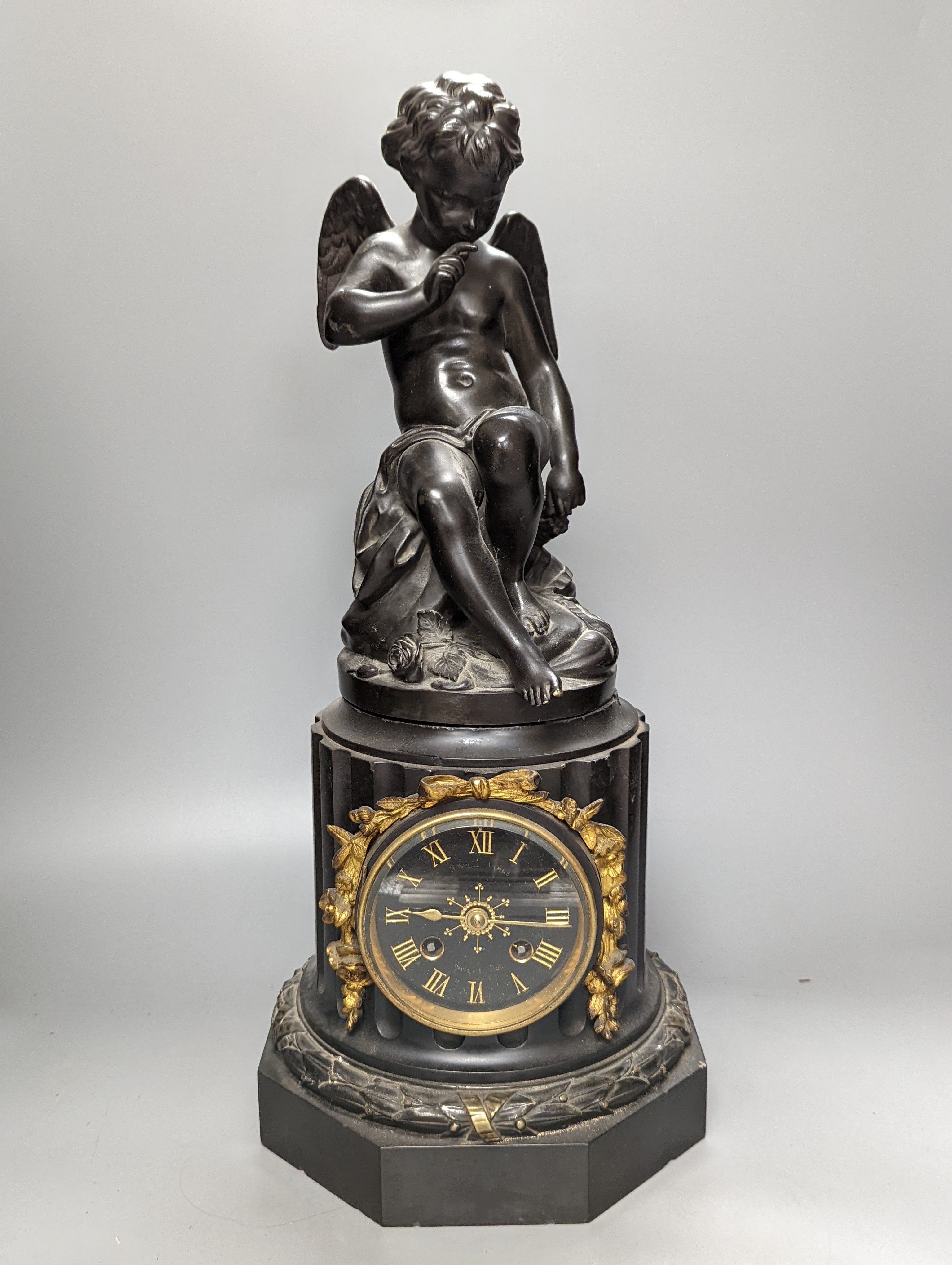 A Late 19th century French bronze and black slate mantel clock, with cherub surmount, drum movement, height 46cm